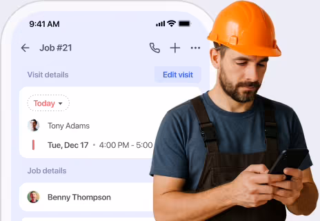 Field worker in a hard hat checking a job on the FieldVibe app