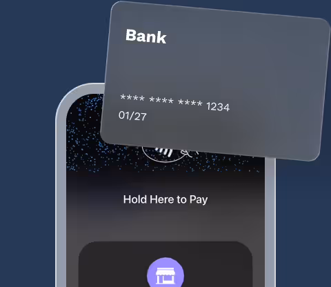 Bank card held over an iPhone showing Hold Here to Pay